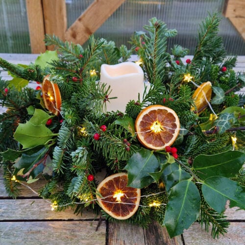 Rustic Evergreen and Orange Slice Centerpiece with Fairy Lights — Christmas Party Decor