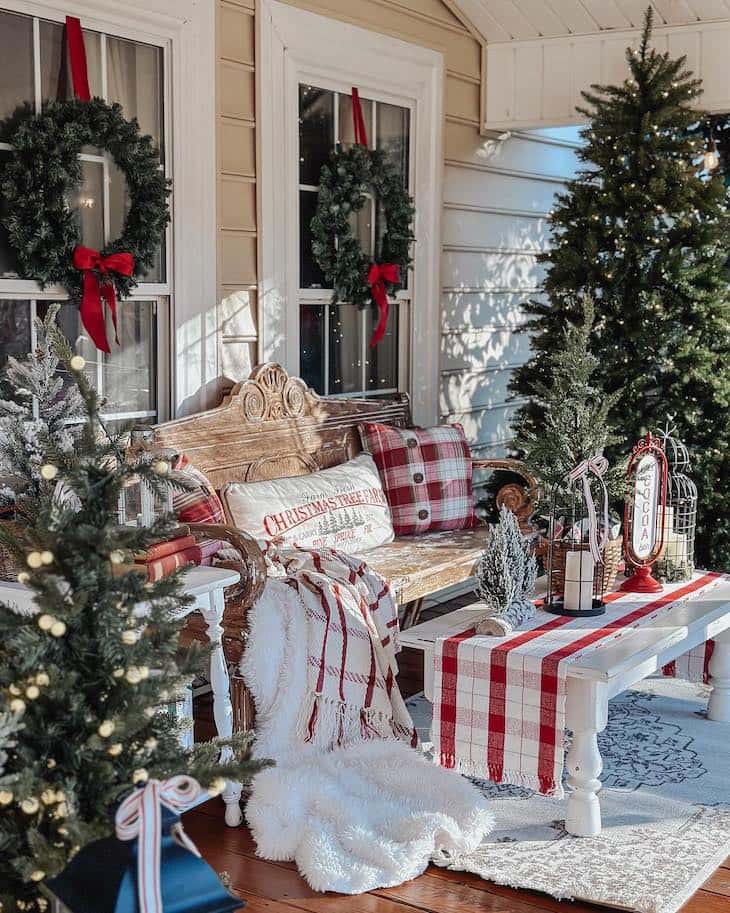 Festive Bench with Plaid Pillows and Miniature Christmas Trees — Farmhouse Christmas Porch