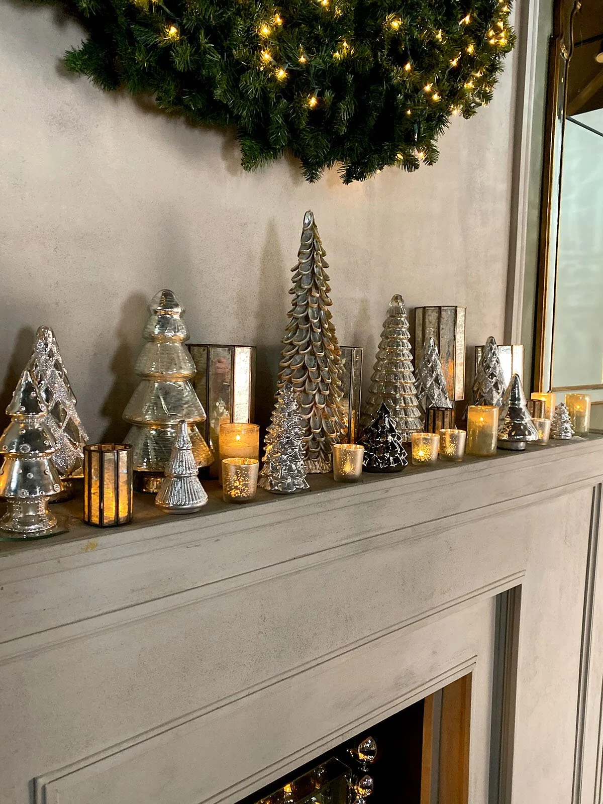 Glamorous Mantel with Silver and Glass Christmas Trees and Candlelight Glamorous Mantel with Silver and Glass Christmas Trees and Candlelight — Christmas Fireplace Decor