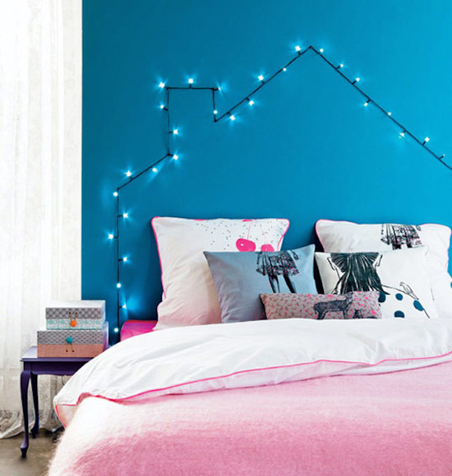 Eclectic Bedroom with Fairy Lights Arranged in a House Shape Above the Bed — Christmas Fairy Lights Headboard