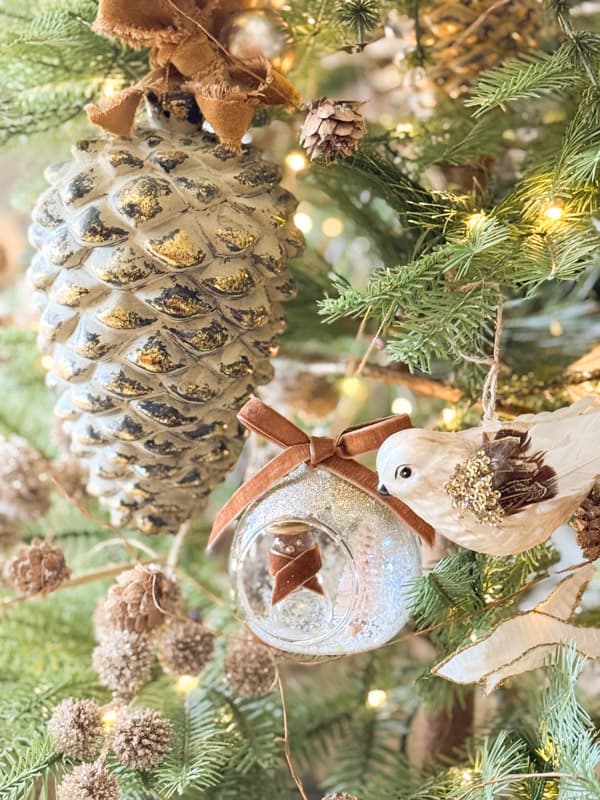 Close-Up on Rustic Pinecone and Velvet Bow Ornaments Close-Up on Rustic Pinecone and Velvet Bow Ornaments — Christmas Tree Trends 2026