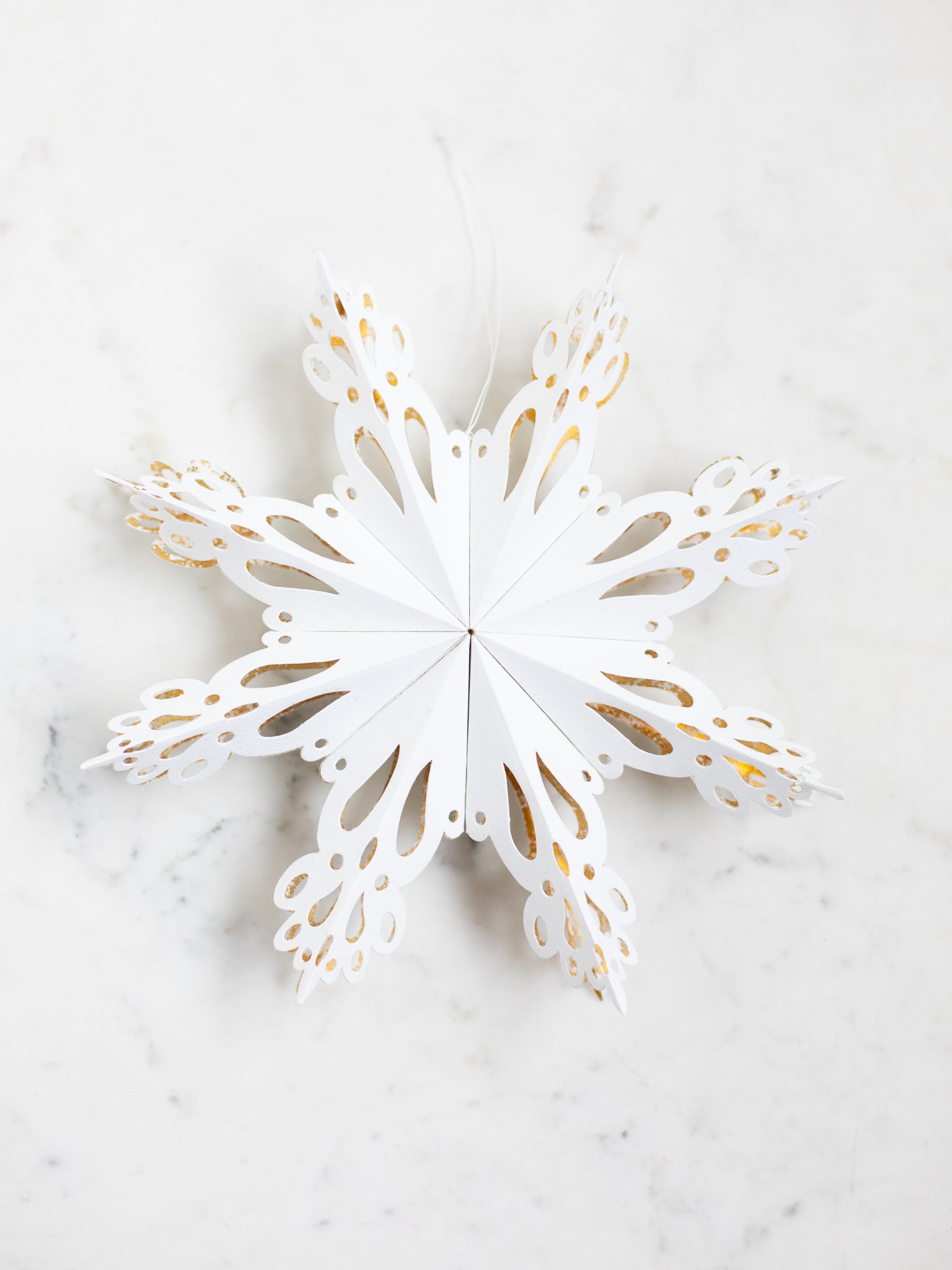 Paper Snowflake with Gold Glitter Accents on Marble — Paper Snowflakes