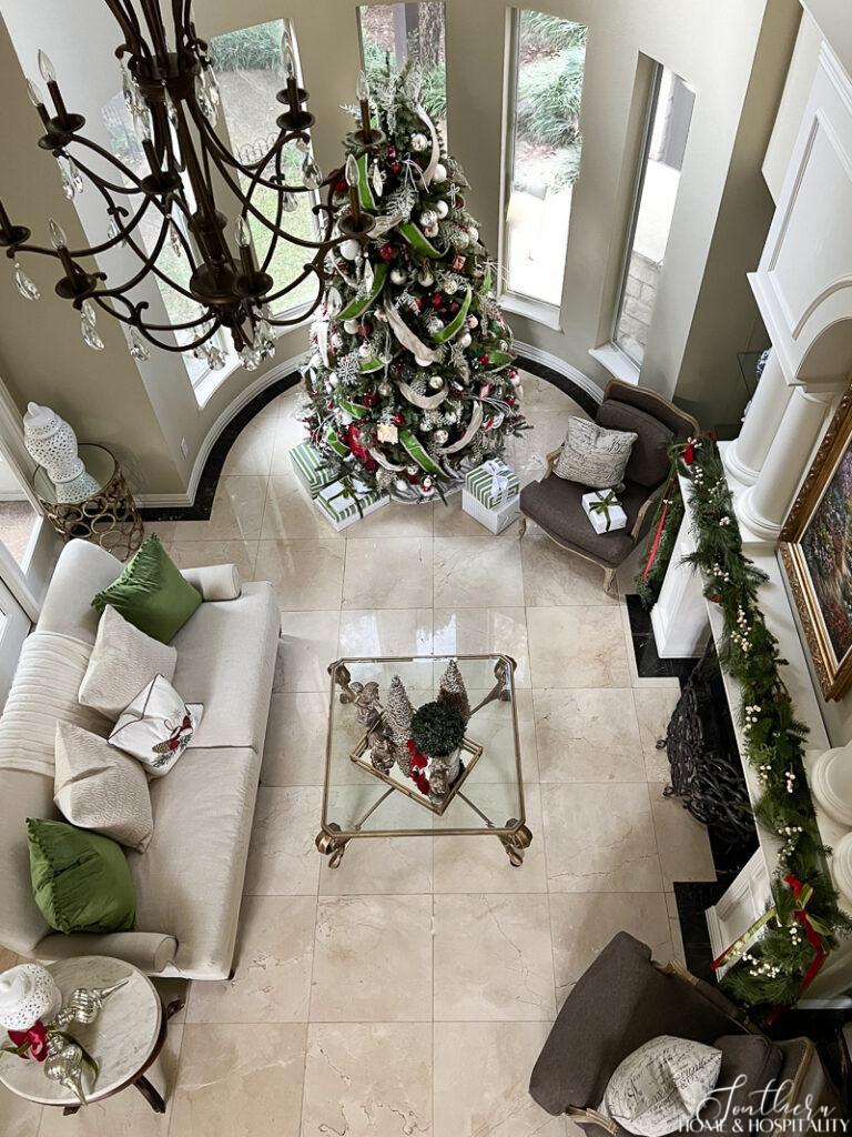 Spacious Living Room with a Grand Christmas Tree and Garlands Spacious Living Room with a Grand Christmas Tree and Garlands — Red and Green Christmas Decor