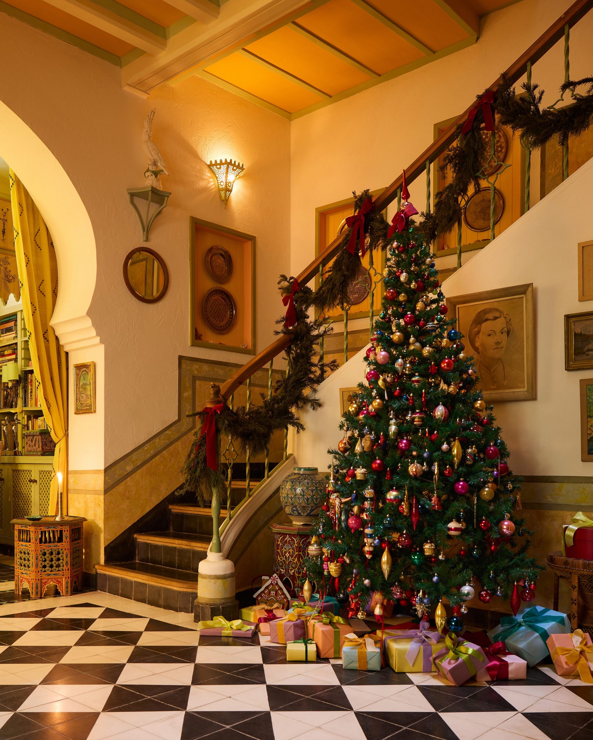 Eclectic Elegance: A Multi-Colored Tree by a Grand Staircase — Elegant Christmas Tree