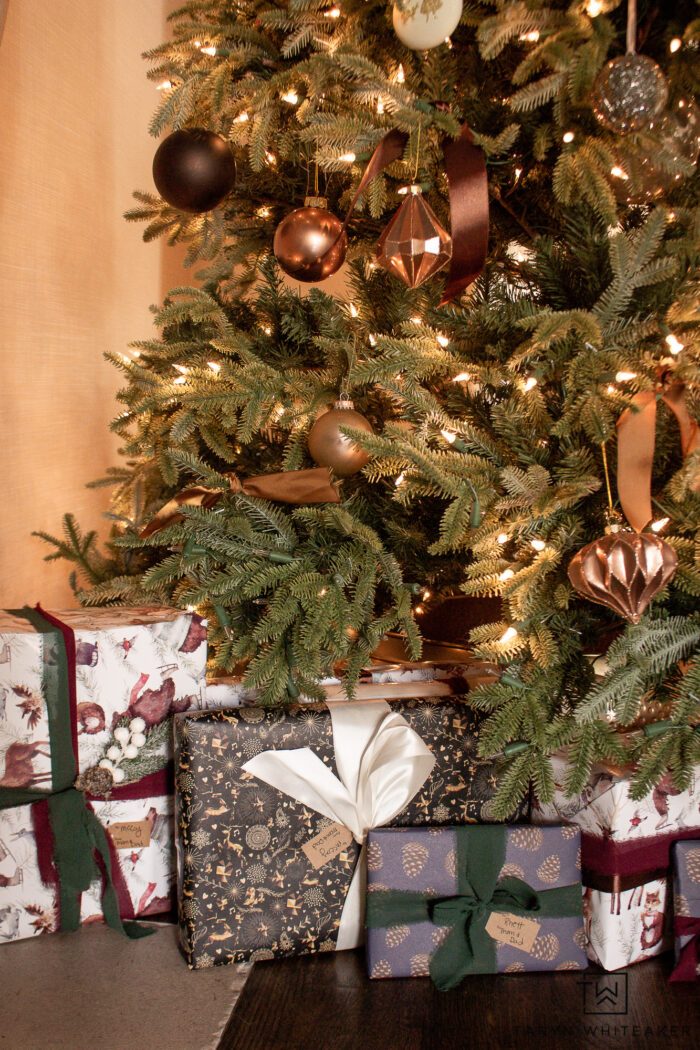 Detailed Gift Presentation Under an Illuminated Christmas Tree — Christmas Gift Wrapping