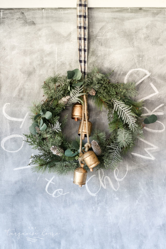 Rustic Evergreen Wreath with Gold Bells and Plaid Ribbon on Chalkboard — DIY Christmas Wreath