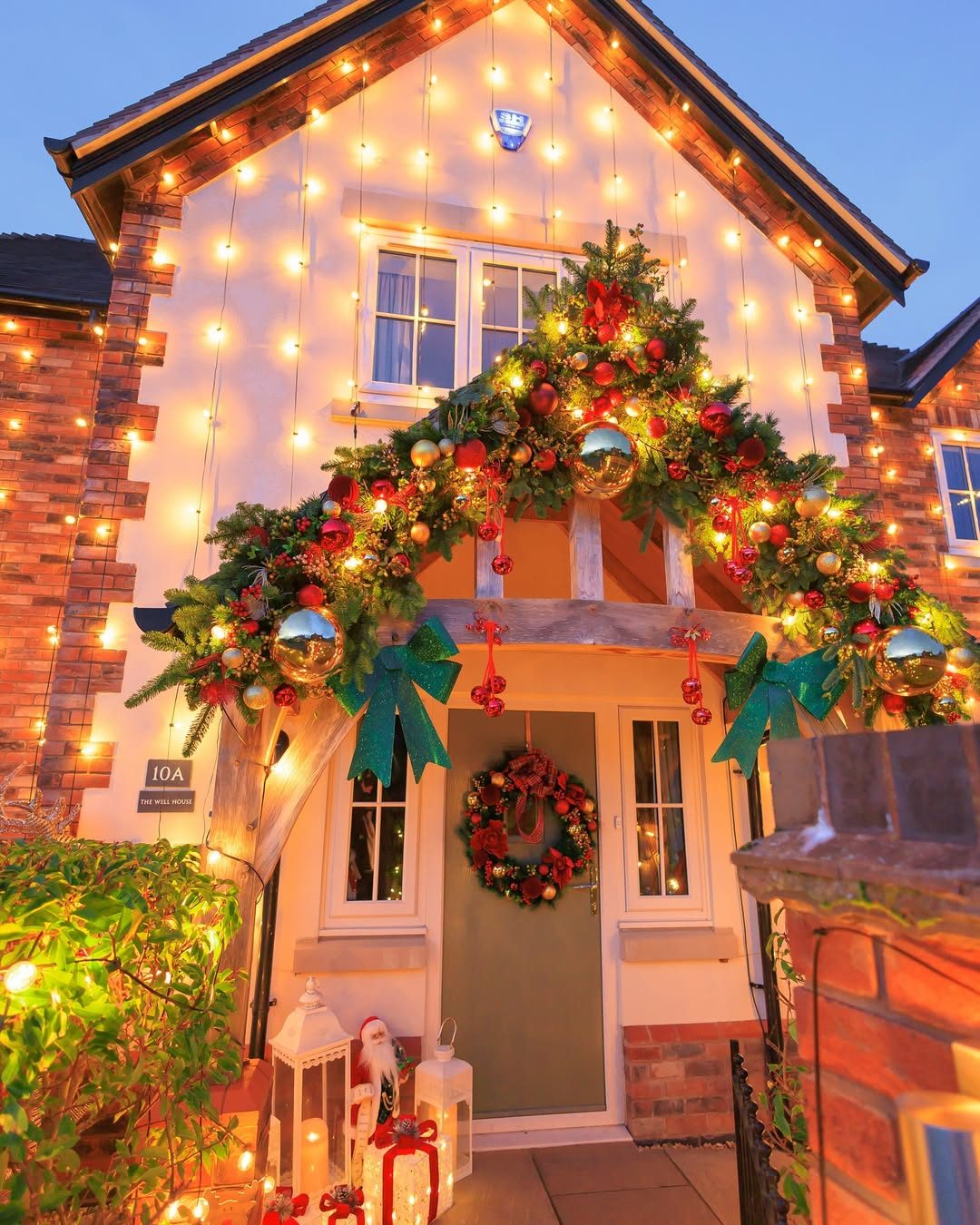 Elaborate Garland Arch and String Lights at Entrance — Outdoor Christmas Lights