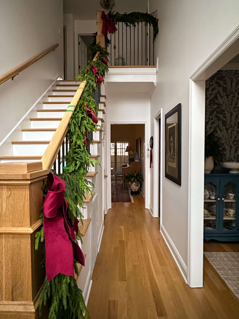 Spacious Hallway with Abundant Red Velvet Bows Spacious Hallway with Abundant Red Velvet Bows — Christmas Staircase Decor