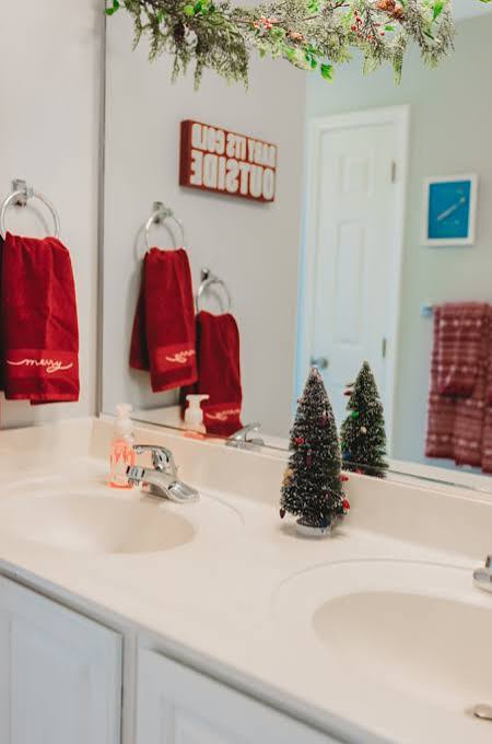 Modern Double Vanity with Miniature Trees and Red Festive Towels Modern Double Vanity with Miniature Trees and Red Festive Towels — Christmas Bathroom Decor