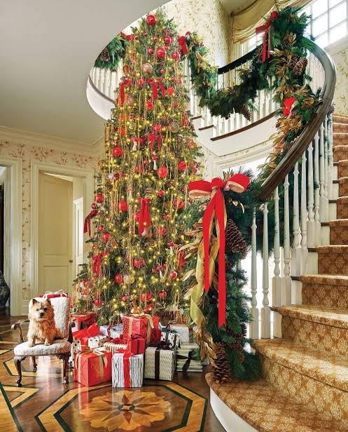 Festive Traditional Entryway with Large Christmas Tree and Staircase Garland — Traditional Christmas Decor