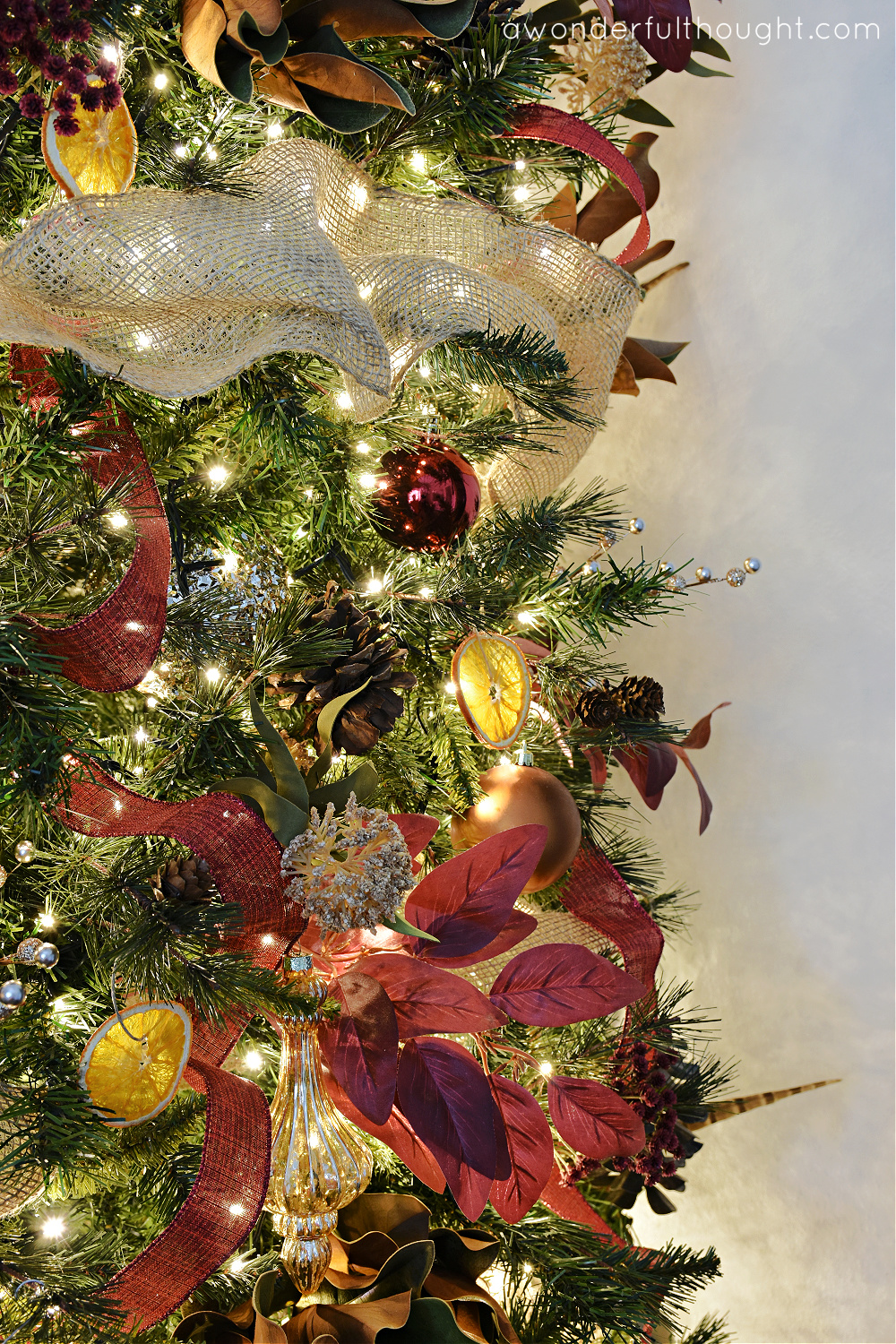 Rustic Christmas Tree with Burgundy Poinsettias and Dried Oranges — Burgundy Christmas Decor