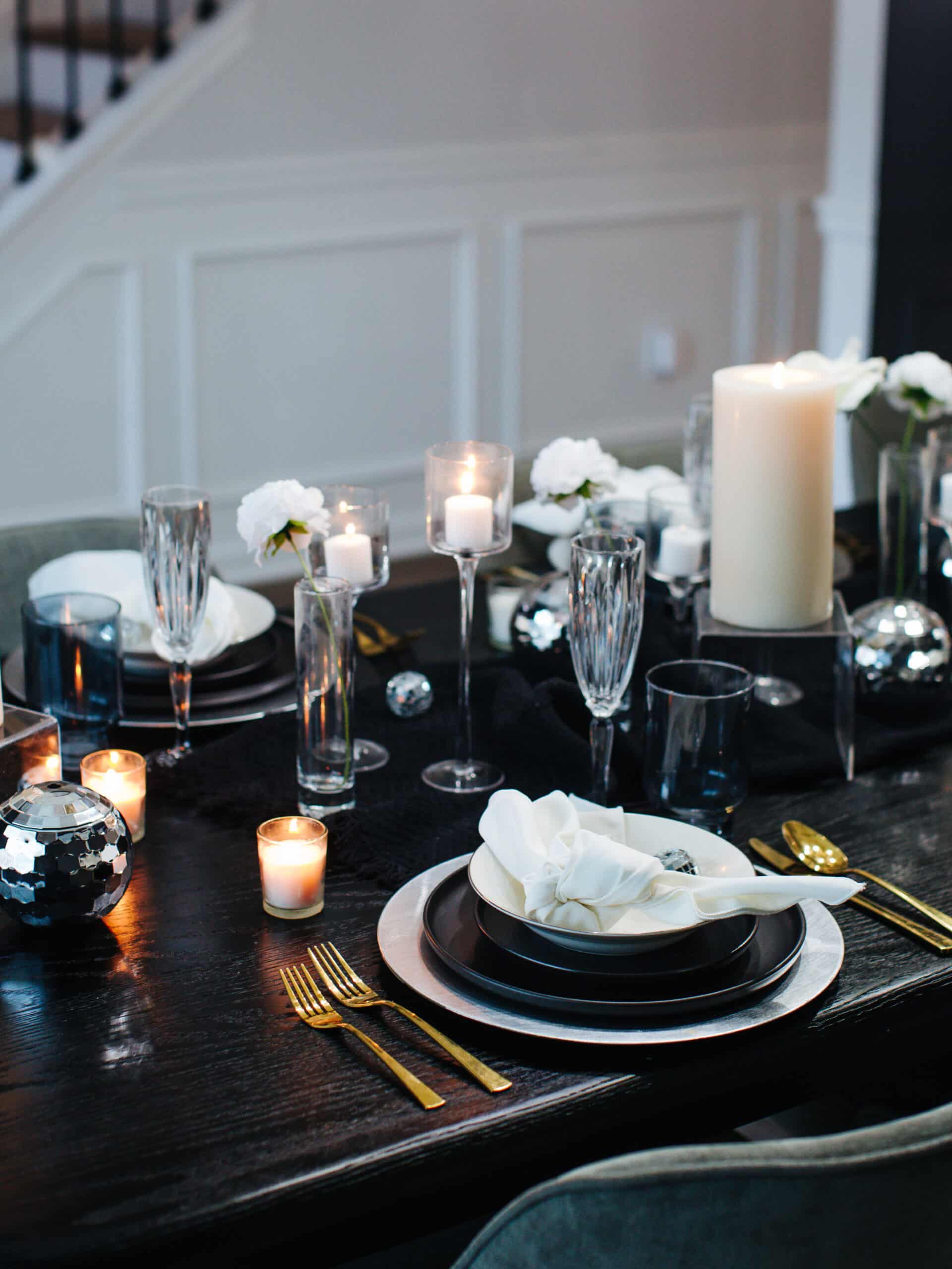 Ambient Candlelit Evening Elegant Black, White, and Gold New Year's Eve Table Setting Ambient Candlelit Evening Elegant Black, White, and Gold New Year's Eve Table Setting — New Years Eve Table Decor