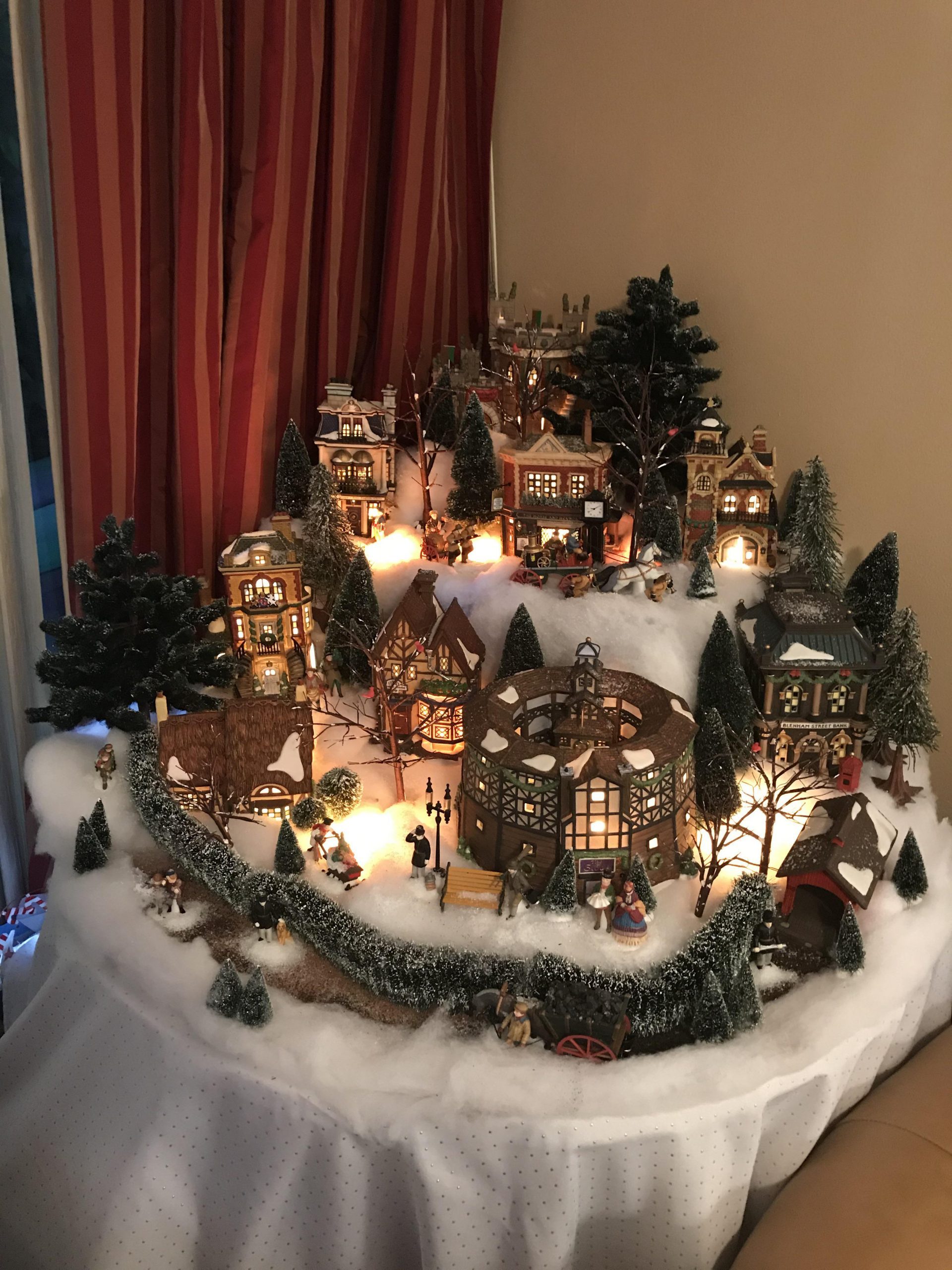 Illuminated Traditional Village on a Draped Table Illuminated Traditional Village on a Draped Table — Christmas Village Display