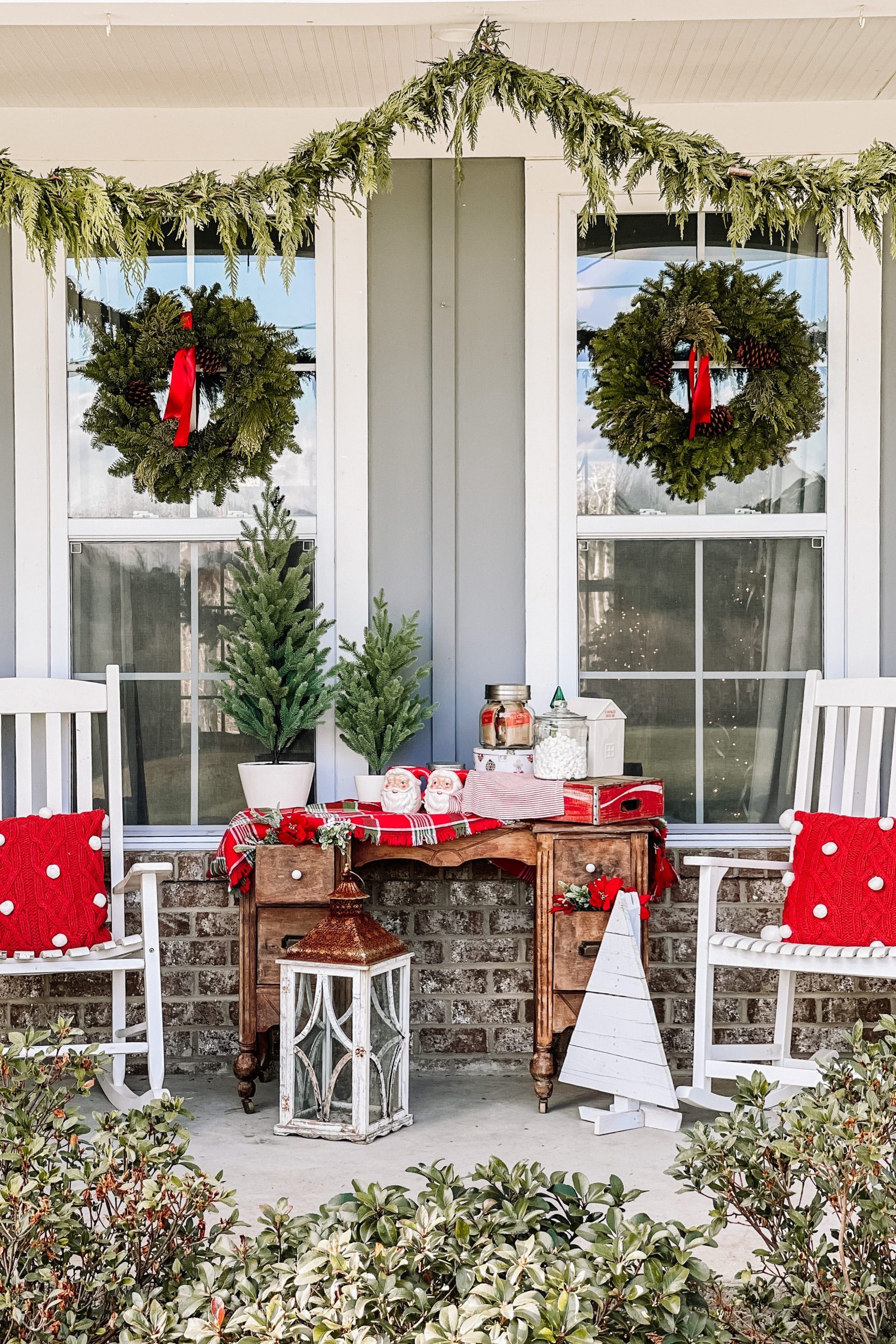 Symmetrical Porch with White Rocking Chairs and Wreaths on Windows — Farmhouse Christmas Porch
