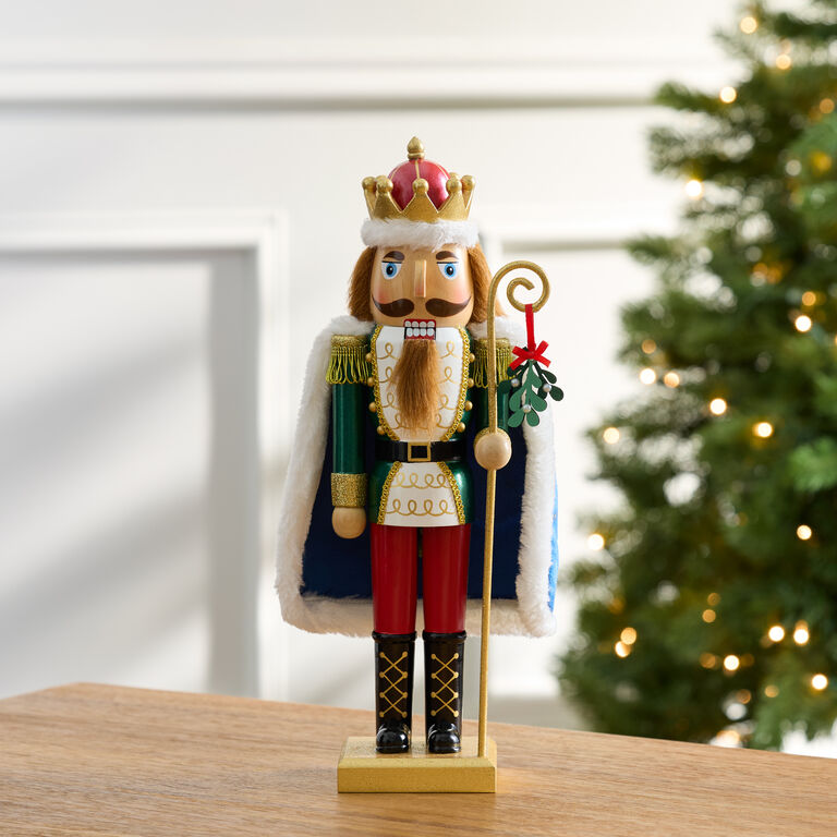 Classic Nutcracker with Mistletoe Staff on a Wooden Table Classic Nutcracker with Mistletoe Staff on a Wooden Table — Nutcracker Christmas Decor