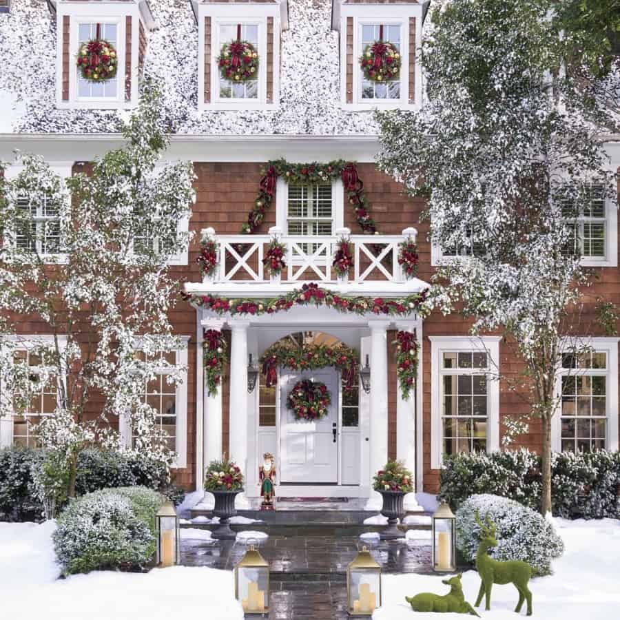 Grand Entrance with Abundant Snowy Greenery — Christmas House Exterior Decor