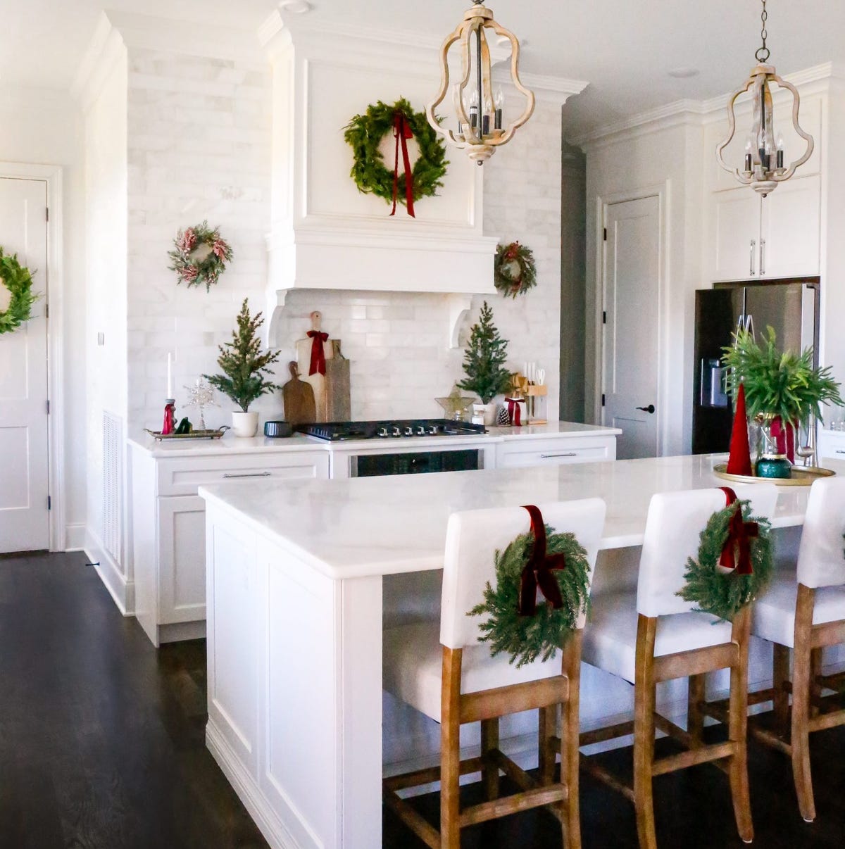 Modern Farmhouse Kitchen with Wreaths on Island Chairs and Mini Trees — Christmas Kitchen Decor