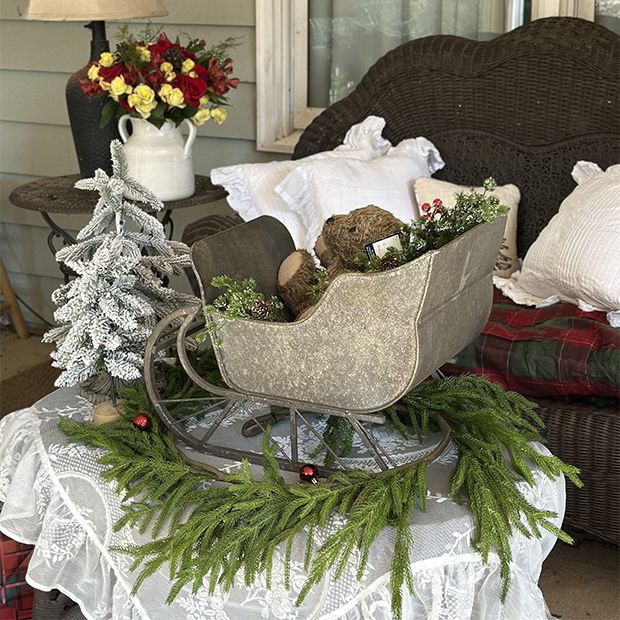 Metallic Sleigh Display on a Porch Table — Rustic Christmas Decor
