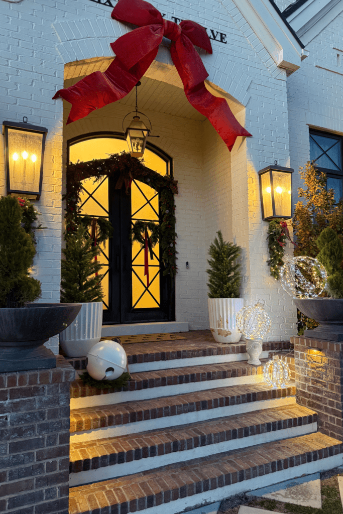 Elegant Christmas Entrance with Oversized Red Bow Elegant Christmas Entrance with Oversized Red Bow — Christmas Porch Decor