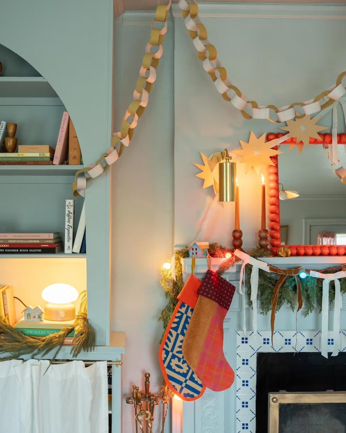Eclectic Mantelpiece with Vibrant Stockings and Garland Eclectic Mantelpiece with Vibrant Stockings and Garland — Christmas Apartment Decor
