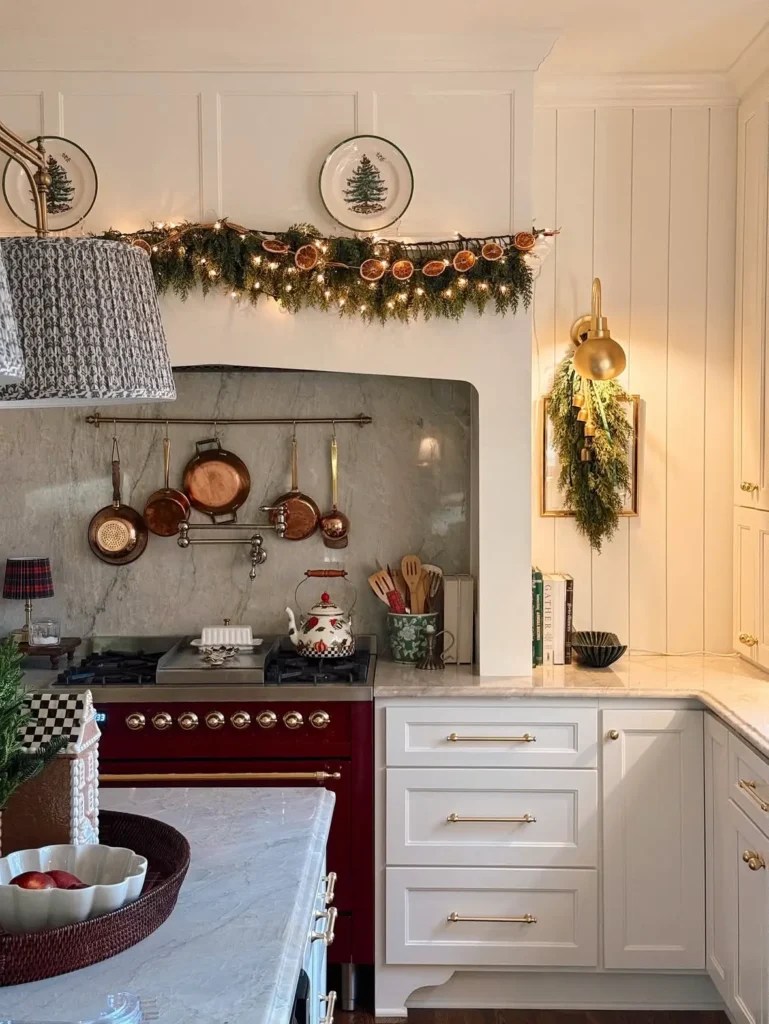 Traditional Kitchen Range with Red Accents and Garland of Dried Oranges — Christmas Kitchen Decor