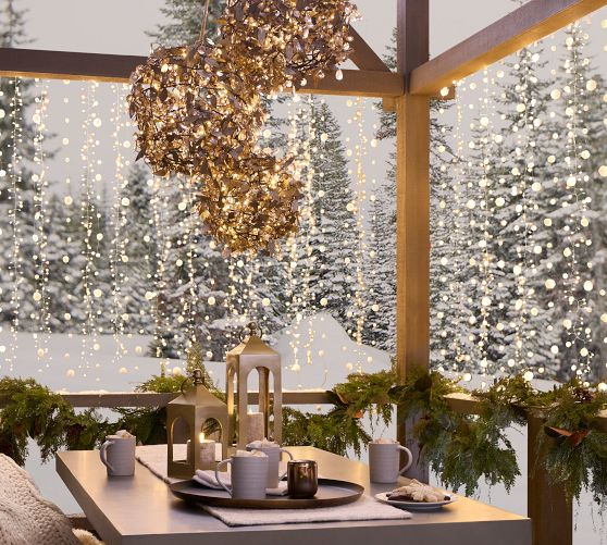 Cascading Lights and Rustic Table Setting on a Covered Porch — Christmas Balcony Decor