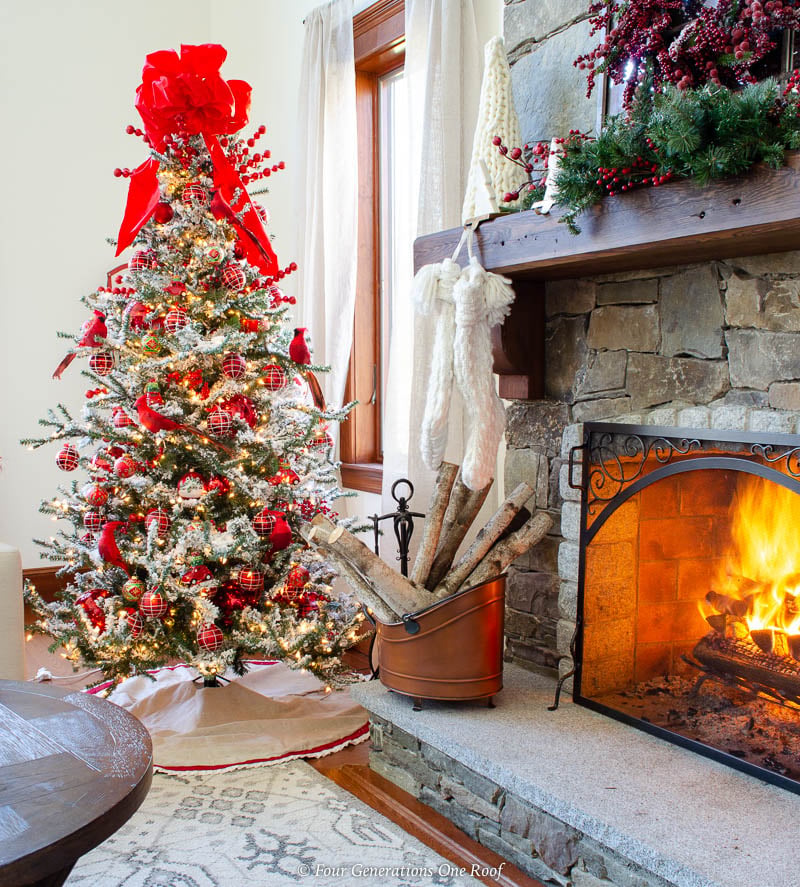 Traditional Flocked Tree with Red and White Ornaments by Fireplace — Christmas Tree Color Schemes