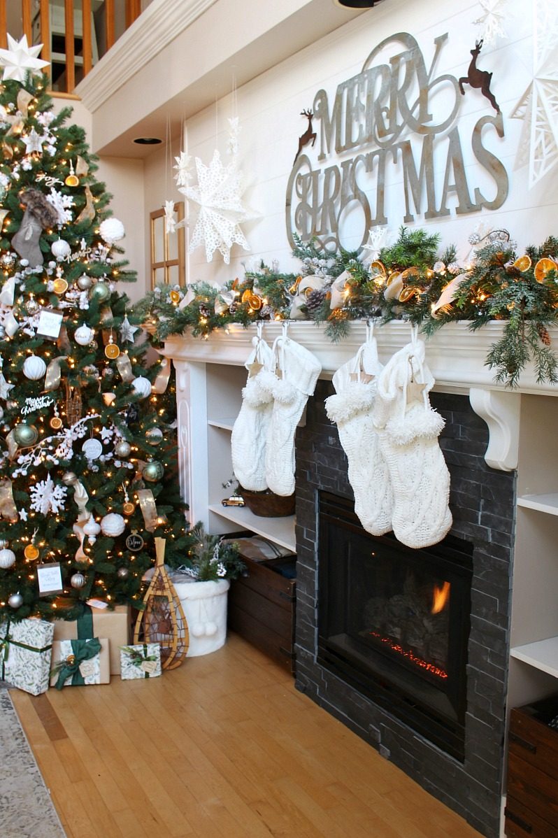 Modern Stone Fireplace with Dried Orange Garland and Cozy Glow Modern Stone Fireplace with Dried Orange Garland and Cozy Glow — Christmas Fireplace Decor