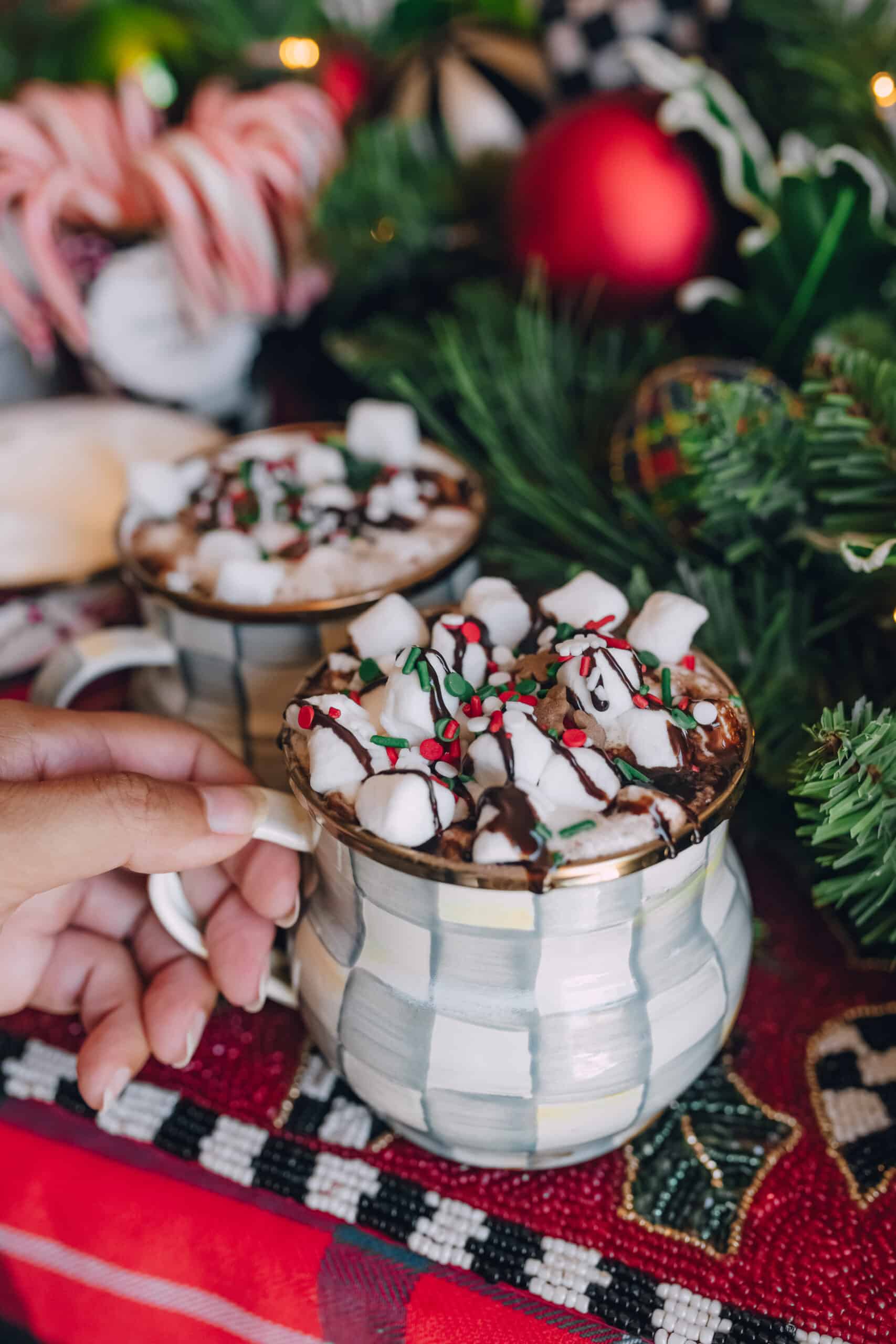 Cozy Living Room Hot Cocoa Mugs with Christmas Tree Accents — Christmas Hot Cocoa Bar
