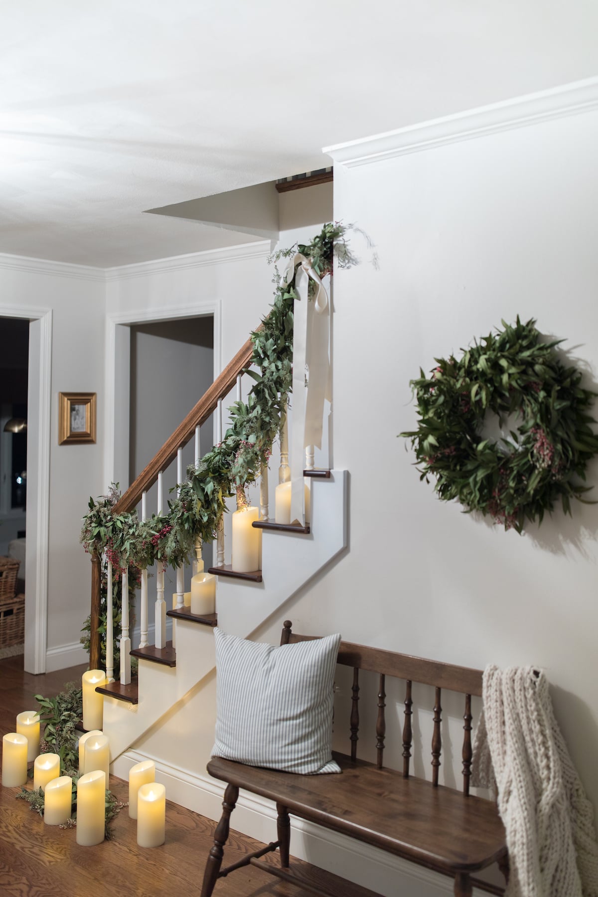 Warm Hallway with Pine Garland and Pillar Candles Warm Hallway with Pine Garland and Pillar Candles — Christmas Staircase Decor