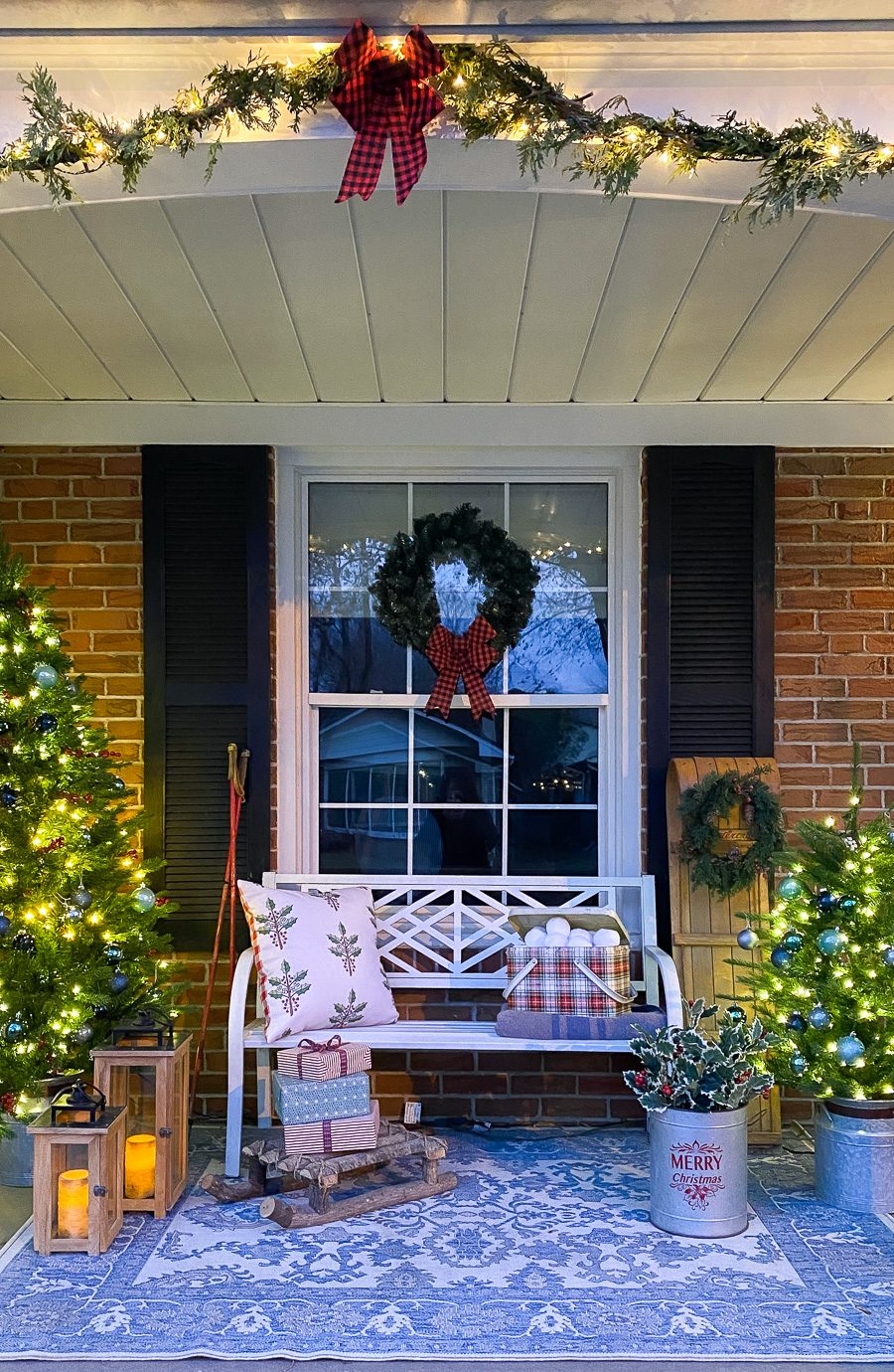 Cozy Porch with Illuminated Trees and Festive Pillows Cozy Porch with Illuminated Trees and Festive Pillows — Christmas Front Door Decor