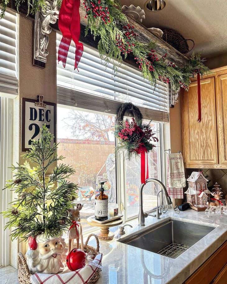 Traditional Kitchen Sink Area with Abundant Greenery, Mini Tree, and Wreath — Christmas Kitchen Decor