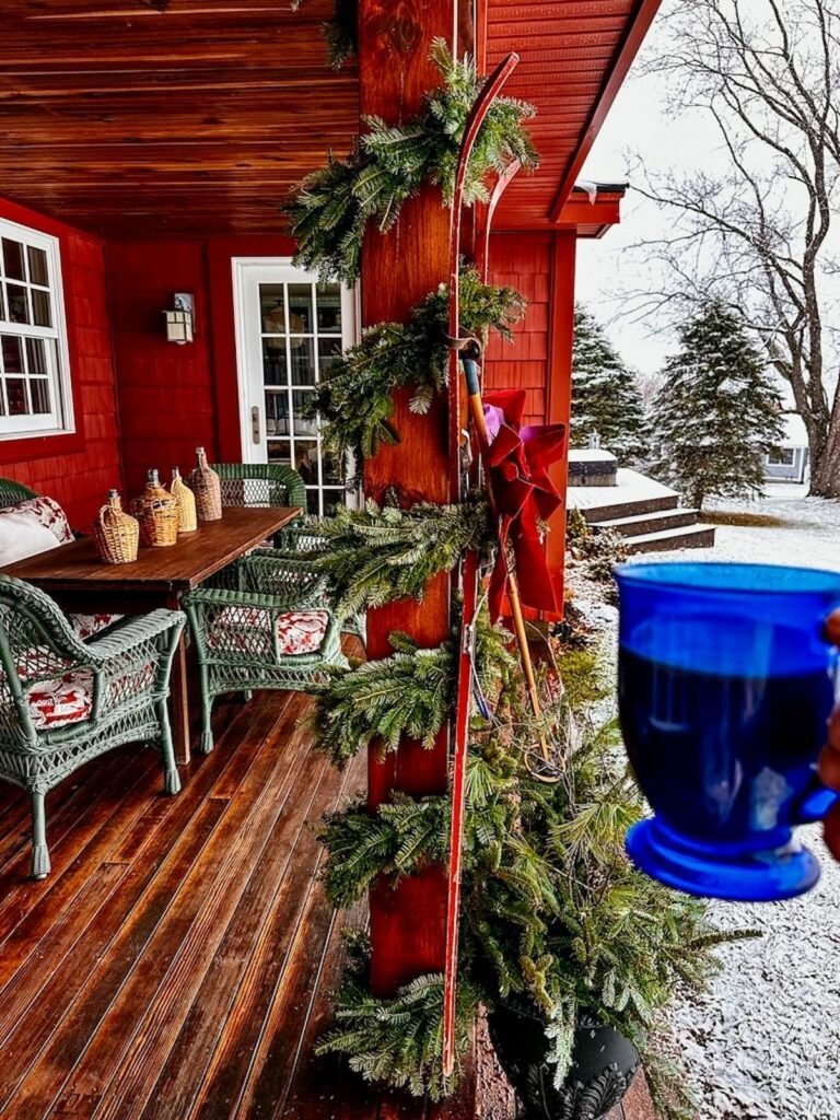 Rustic Porch with Vintage Skis and Pine Garland Rustic Porch with Vintage Skis and Pine Garland — Red and Green Christmas Decor