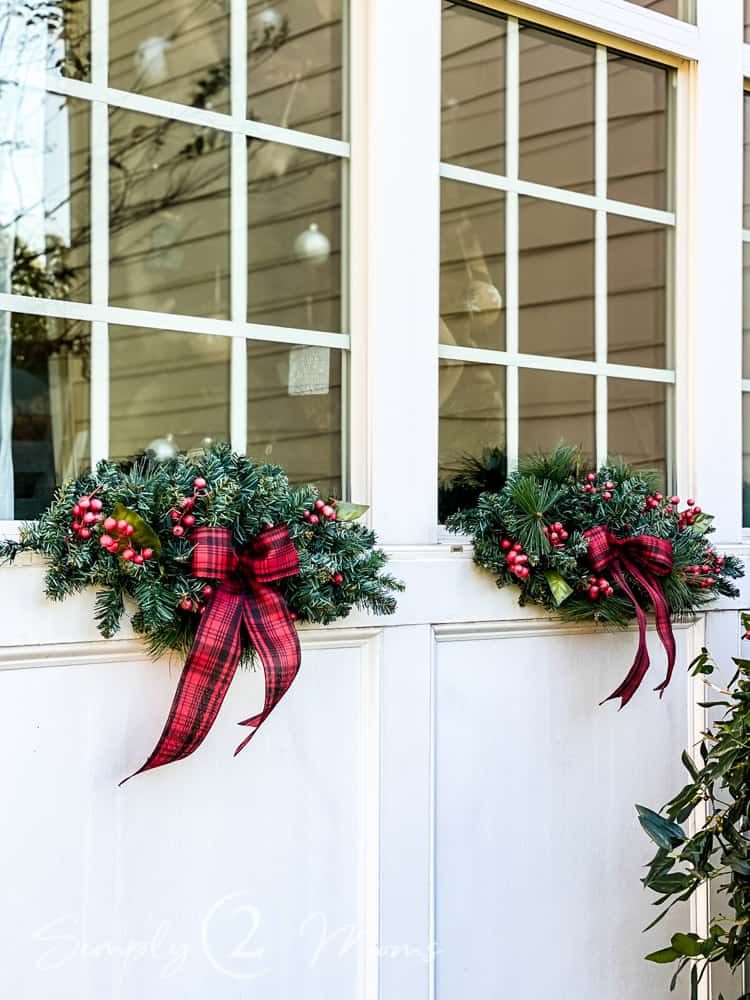 Traditional Outdoor Swags with Evergreen Boughs and Tartan Plaid Bows Traditional Outdoor Swags with Evergreen Boughs and Tartan Plaid Bows — Christmas Window Decor Outdoor