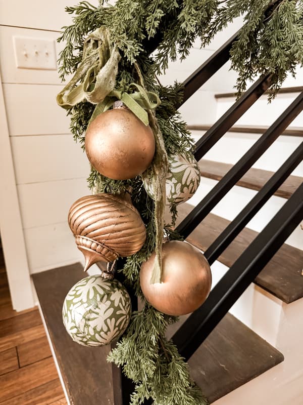Faux Pine Garland with Gold and White Christmas Ornaments on Staircase — Dollar Tree Christmas Decor