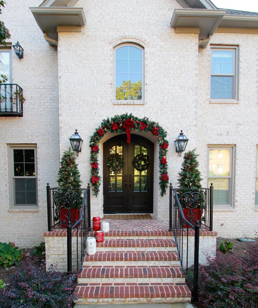 Red Planters with Christmas Trees Flanking a Festive Entryway — Christmas Porch Planters