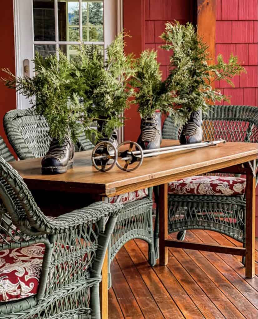 Rustic Porch with Vintage Boots Filled with Evergreen Branches Rustic Porch with Vintage Boots Filled with Evergreen Branches — Winter Porch Decor