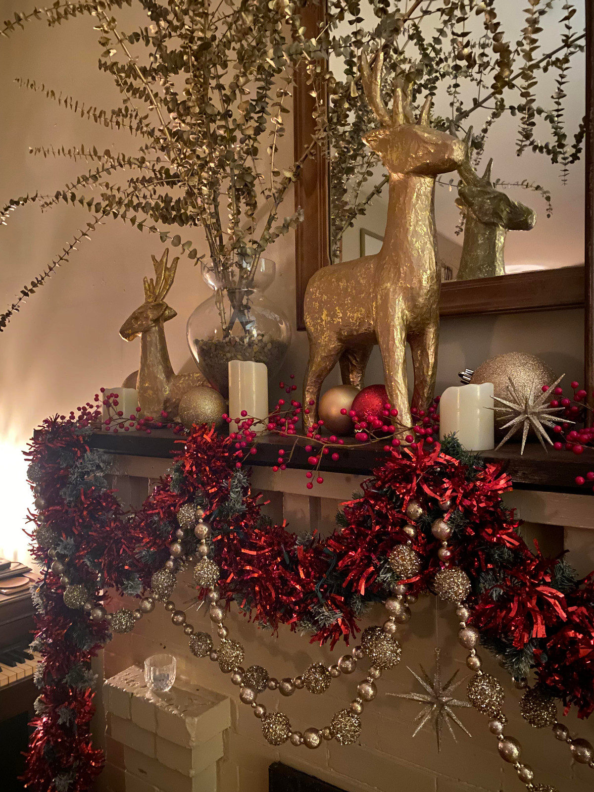 Festive Mantelpiece with Gold Reindeer and Red Garlands Festive Mantelpiece with Gold Reindeer and Red Garlands — Red and Gold Christmas Decor