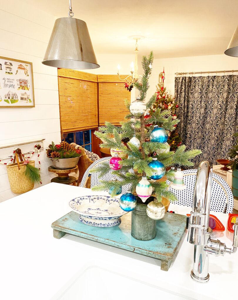 Farmhouse Kitchen with Miniature Christmas Tree on Wooden Stand Farmhouse Kitchen with Miniature Christmas Tree on Wooden Stand — Vintage Christmas Decor