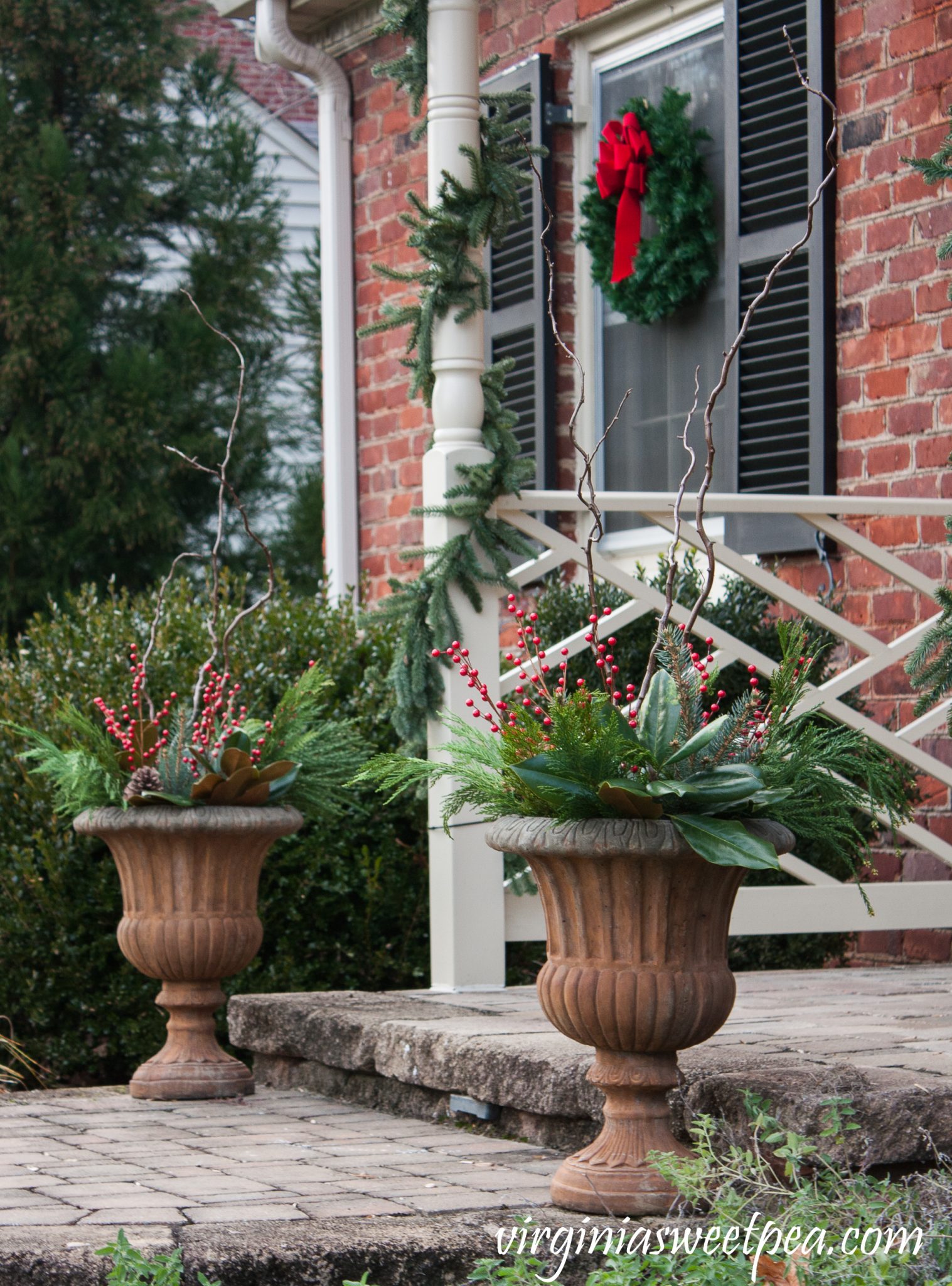 Stone Urn Planters Flanking Porch Steps with Festive Garland — Christmas Porch Planters