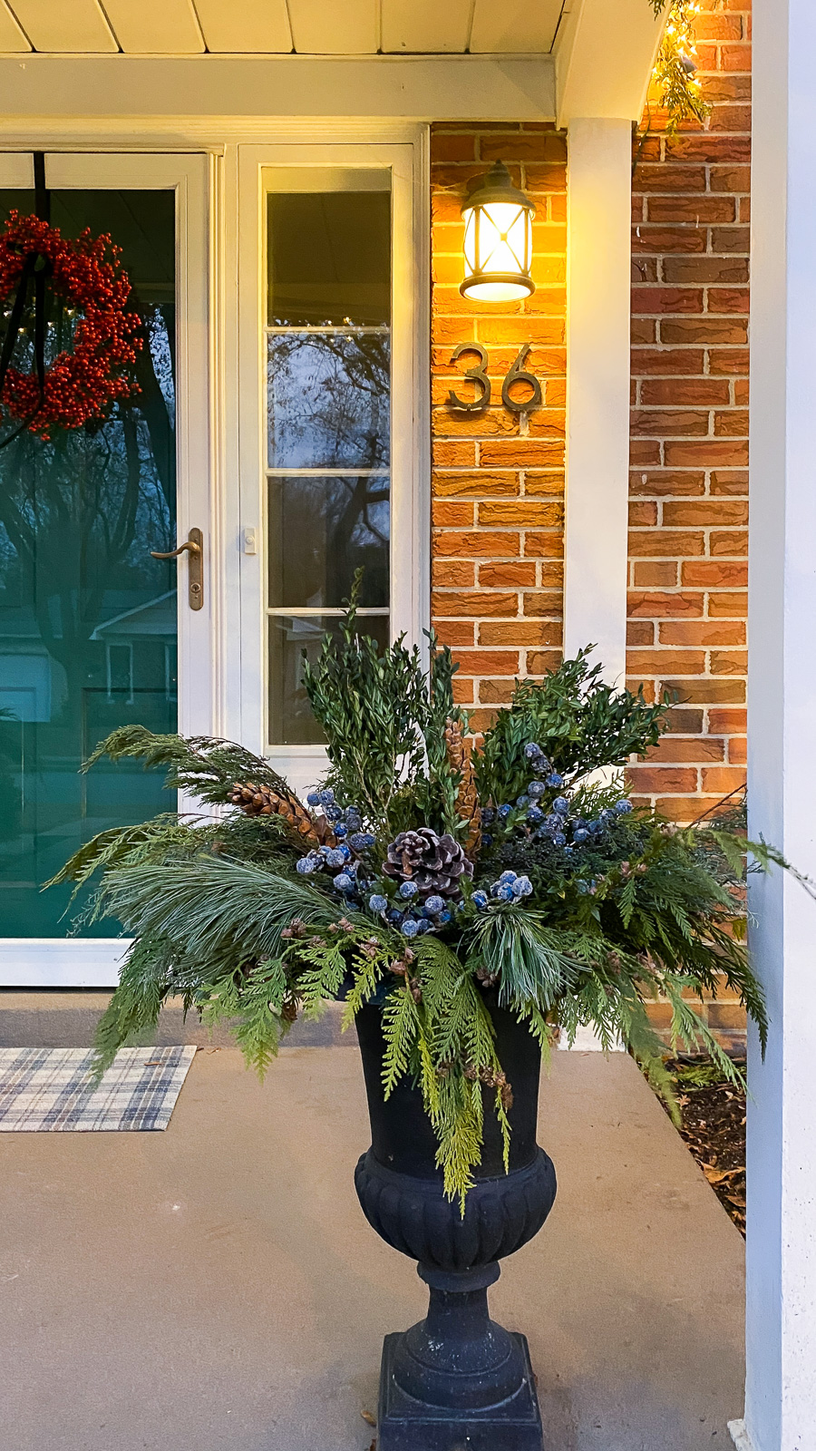 Black Urn Planter Filled with Evergreen and Blue Berries — Christmas Porch Planters