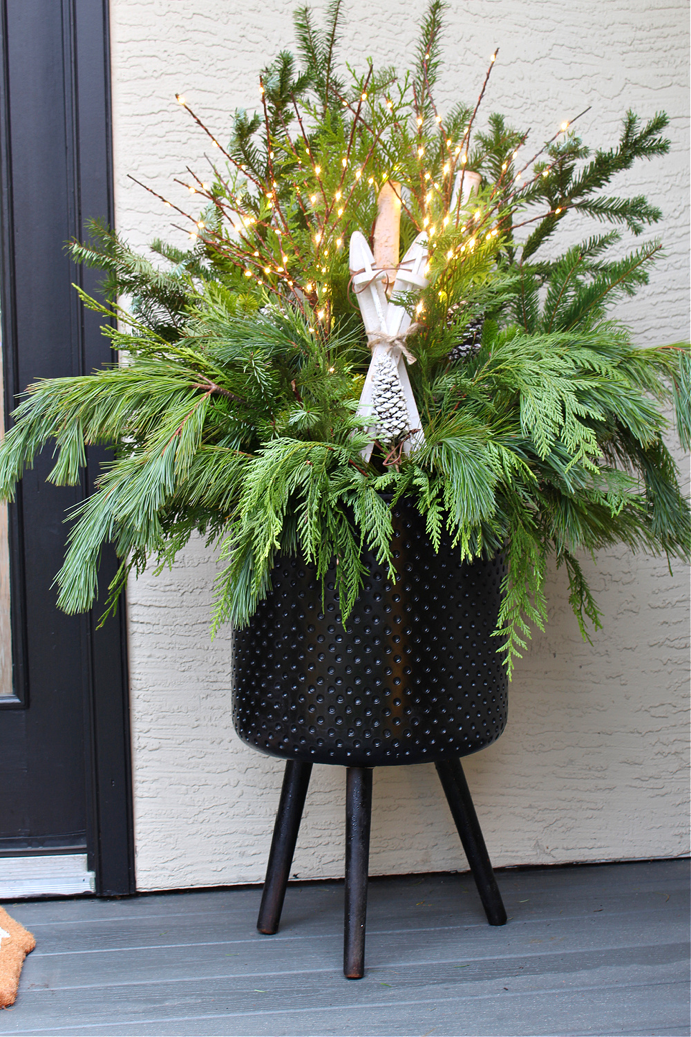Black Metal Planter with Fairy Lights and Wooden Angel — Christmas Porch Planters